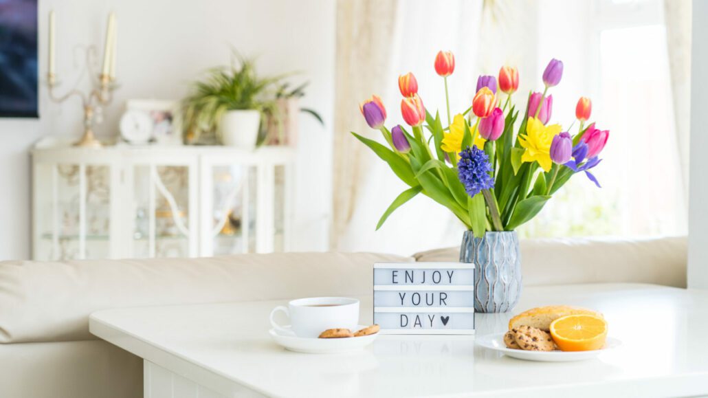 Banner image for the post, Mastering Your Morning Routine: A Guide to Productivity and Success, featuring flowers, coffee, and a sign that reads "Enjoy your day