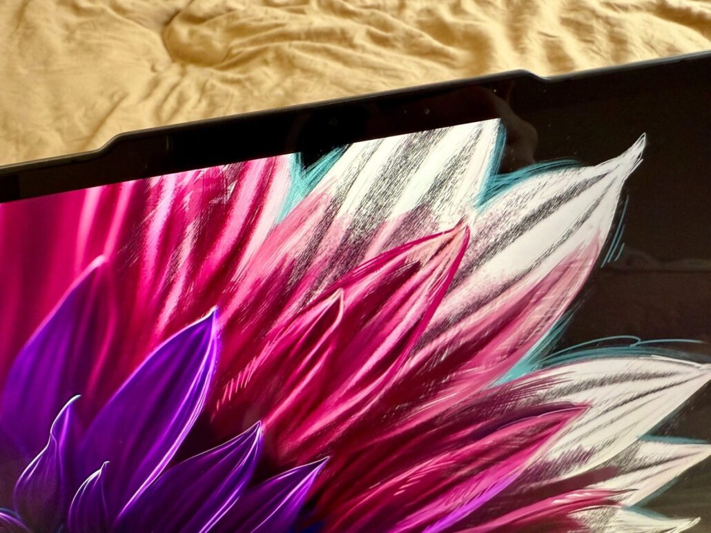 Close-up of the Lenovo Yoga Slim 7i Aura Edition display with a notch design and colorful wallpaper.