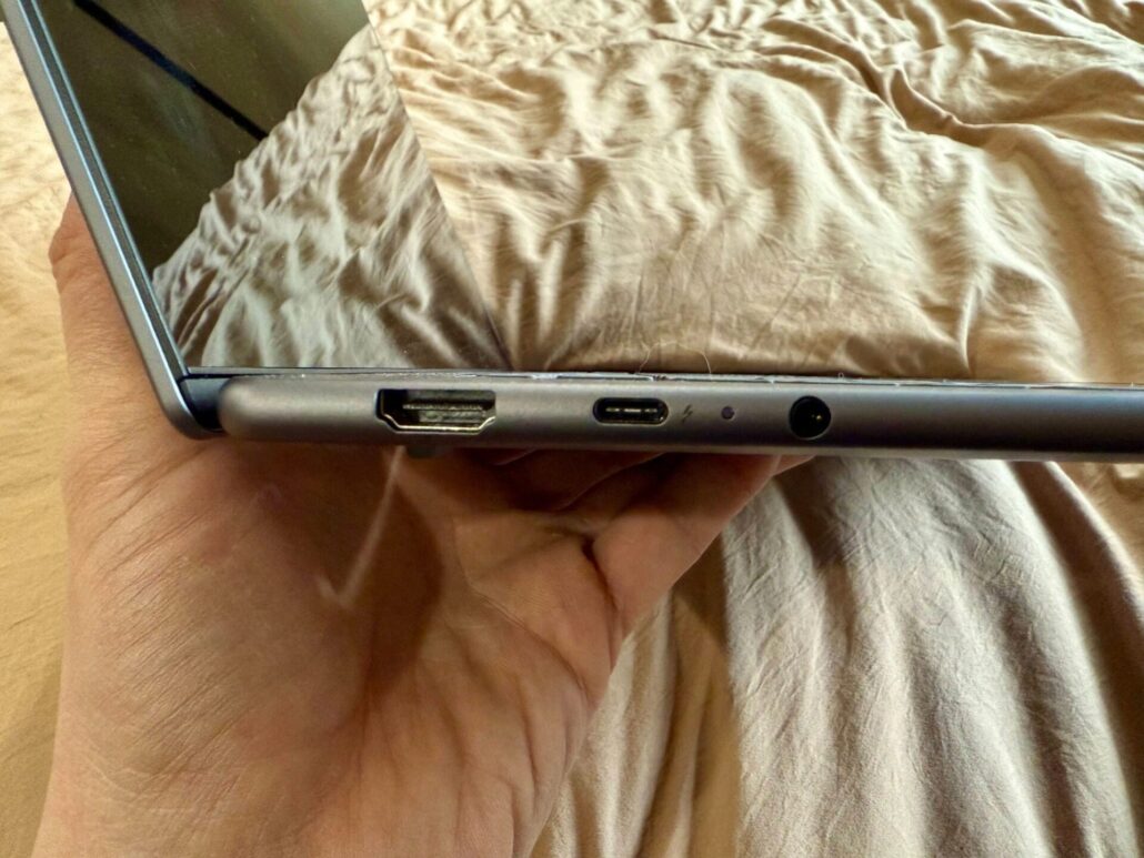 Close-up of the Lenovo Yoga Slim 7i Aura Edition laptop’s left-side ports, including HDMI, USB-C, and headphone jack.