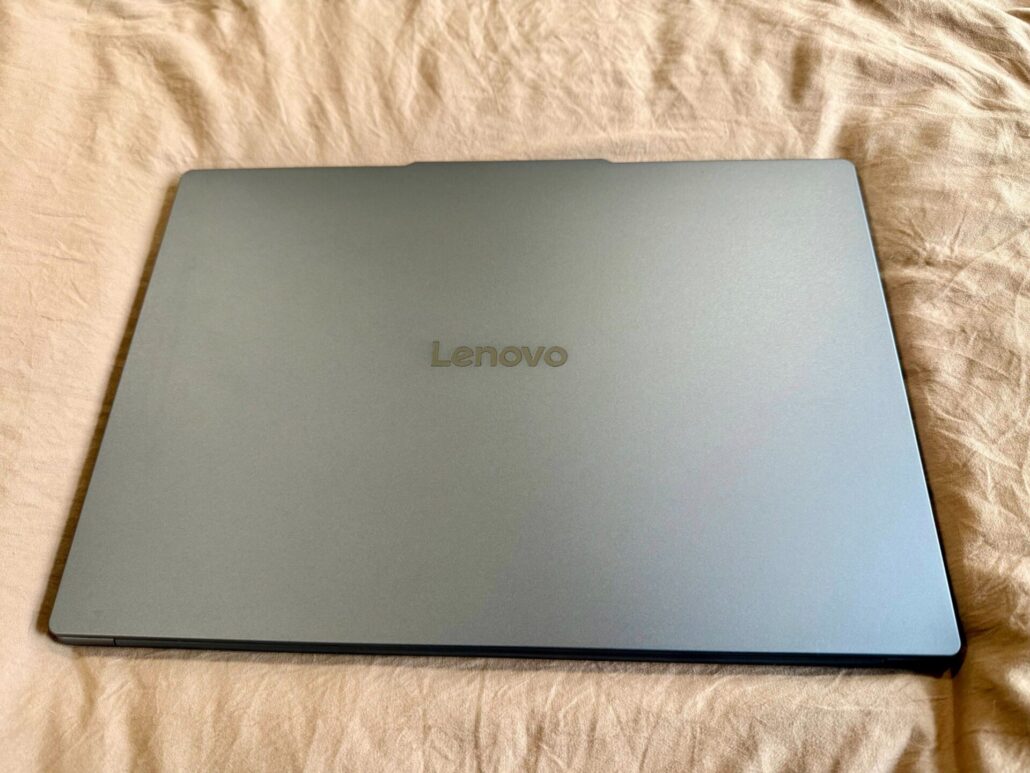 Top view of the Lenovo Yoga Slim 7i Aura Edition with the lid closed, featuring the Lenovo logo.