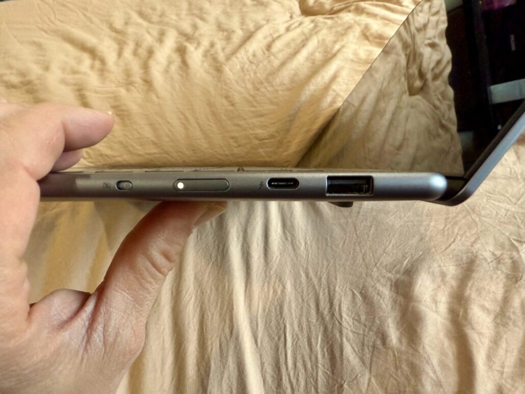 Close-up of the Lenovo Yoga Slim 7i Aura Edition laptop's right-side ports, including USB-A, USB-C, and power button.