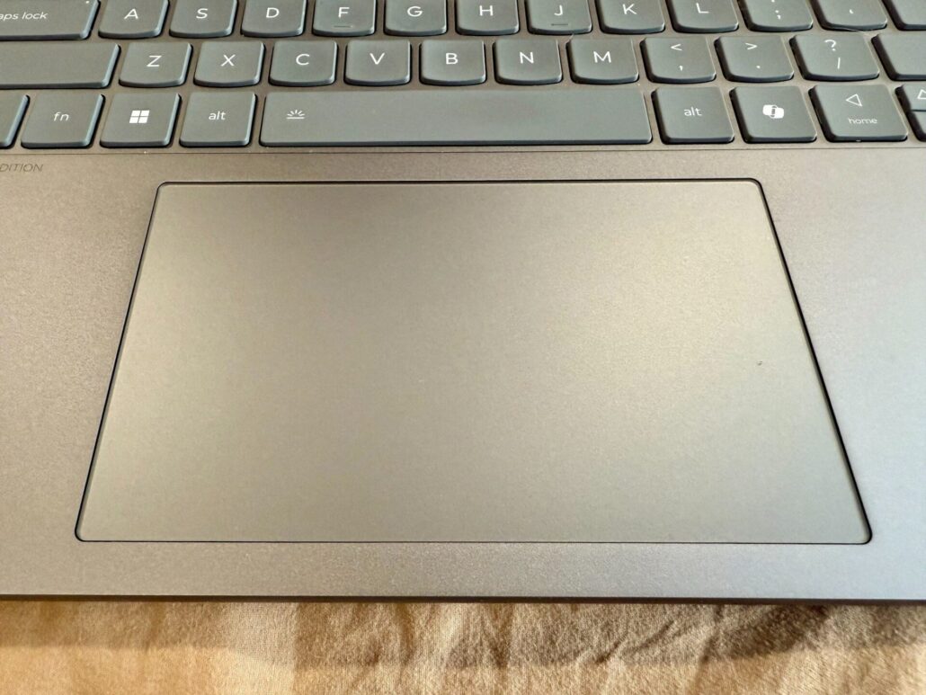 Close-up of the Lenovo Yoga Slim 7i Aura Edition trackpad and surrounding keyboard area.