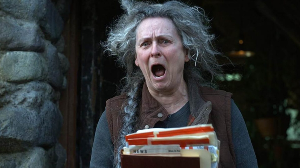 Iris Campbell in Final Destination: Bloodlines (2025), holding documents and reacting in shock – featured in our Final Destination: Bloodlines review.