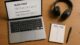 Top-down view of a blogger’s workspace with a laptop displaying a review draft, a pros and cons notepad, and headphones — representing the review writing process.