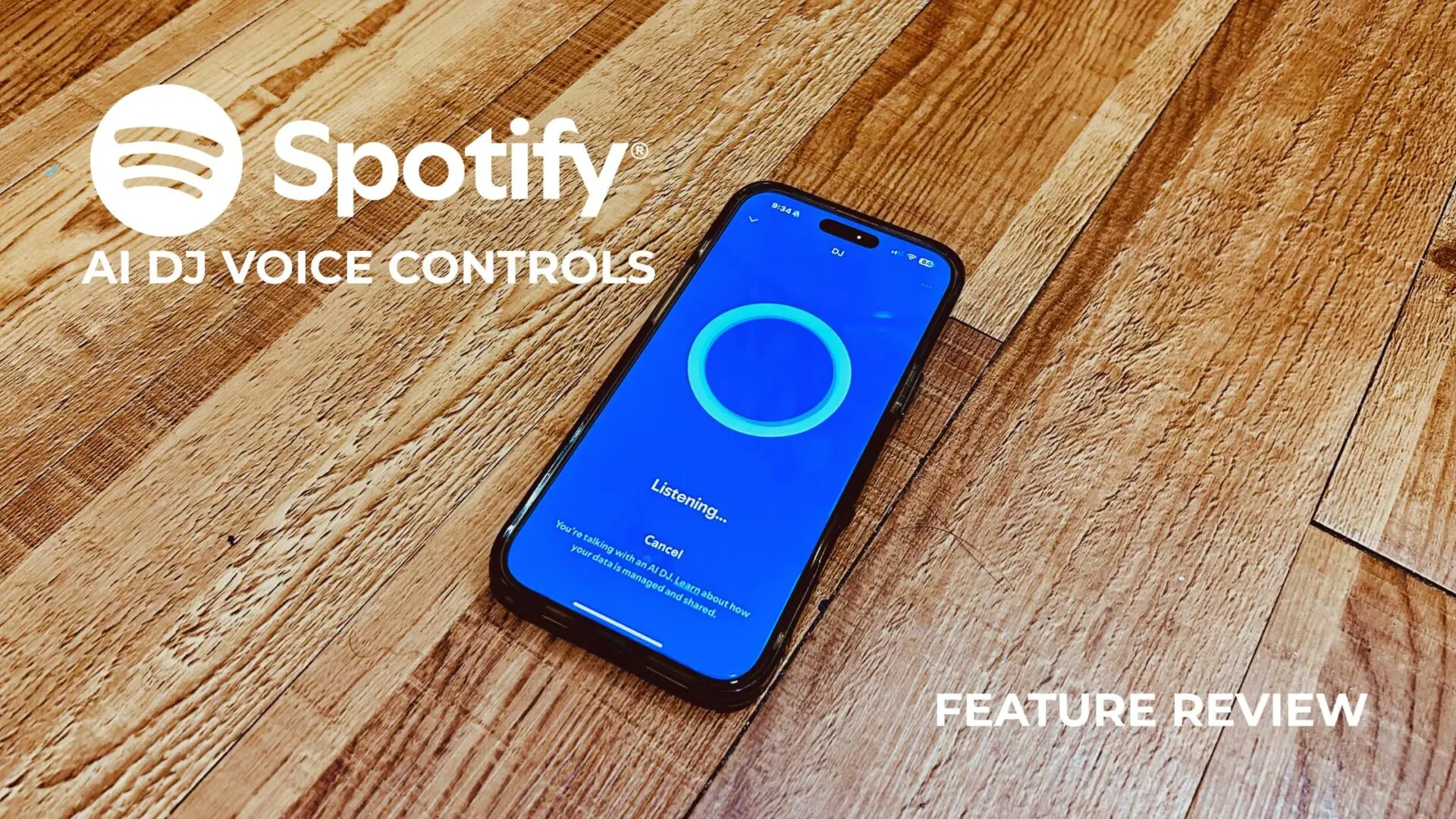 Smartphone displaying Spotify AI DJ voice command interface on a wood floor, with text overlay reading “Spotify AI DJ Voice Controls” and “Feature Review