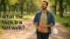 A smiling man walking through a sunlit park with one hand on his stomach, text on image reads “What the heck is a fart walk?”, with a cartoon fart cloud for humorous effect.