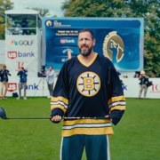 Adam Sandler as Happy Gilmore in the happy gilmore 2 trailer on a golf course wearing a Bruins jersey