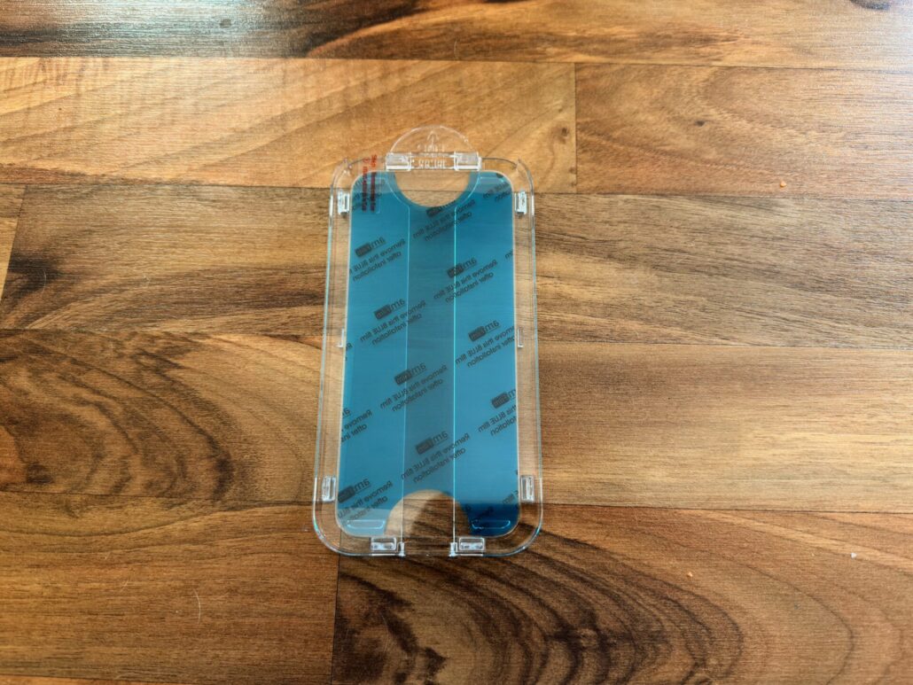 he amFilm auto-alignment installation tray with the tempered glass screen protector pre-loaded and ready for application.