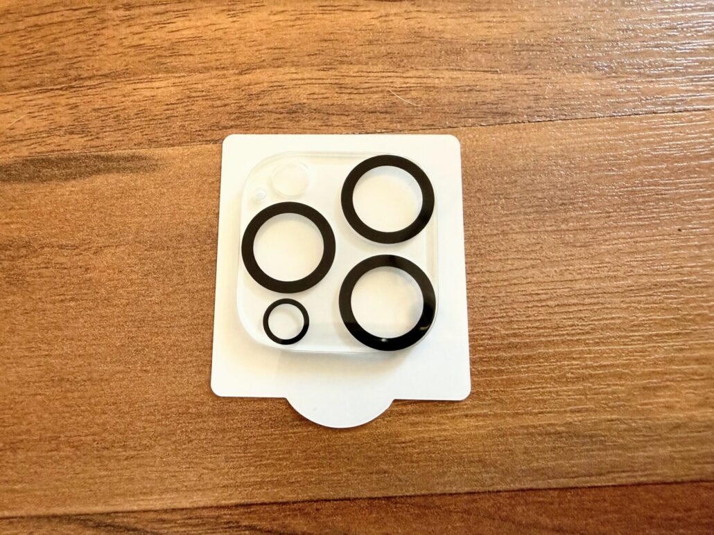 Close-up of the amFilm tempered glass camera lens protectors featuring black rings to prevent flash glare.