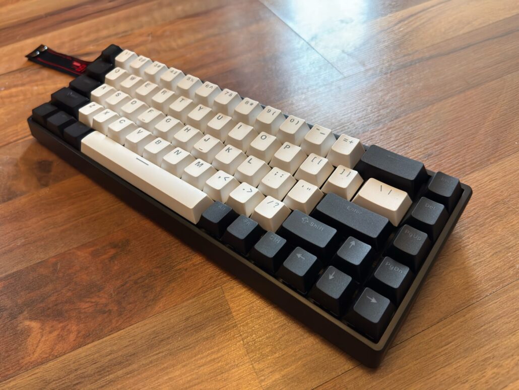 Close-up angled view of the AULA WIN68 HE mechanical gaming keyboard showing the black case and black and white "panda" keycaps.