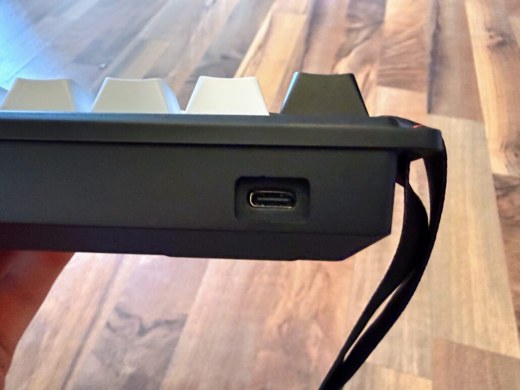 Close-up view of the side profile of the AULA WIN68 HE keyboard showing the recessed USB-C connection port.