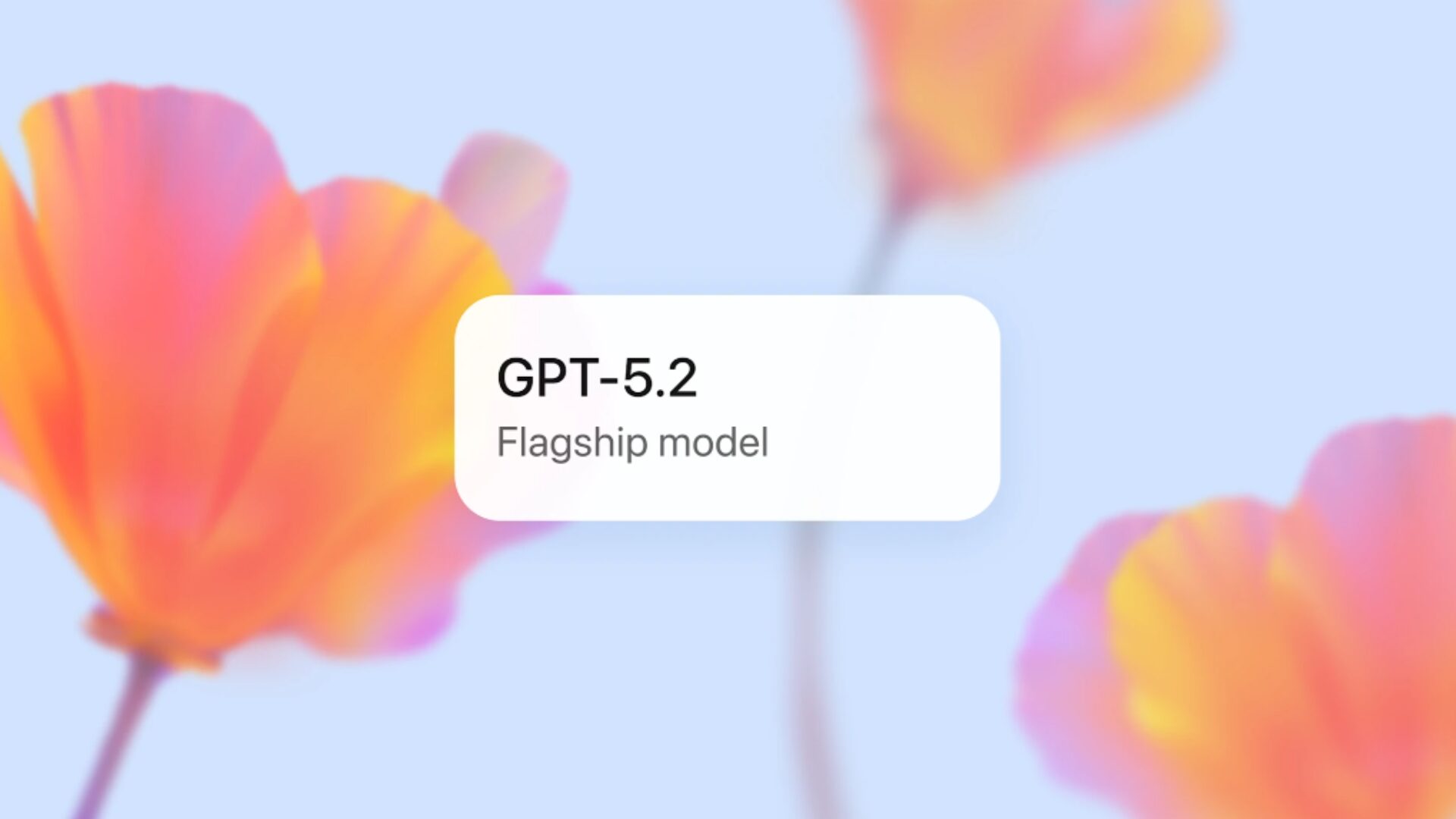 A promotional graphic for the OpenAI GPT-5.2 release, featuring a white badge that reads "GPT-5.2 Flagship model" against a soft, blurred floral background.