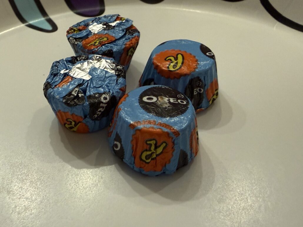 Individually wrapped Reese’s Oreo Miniature Cups on a plate