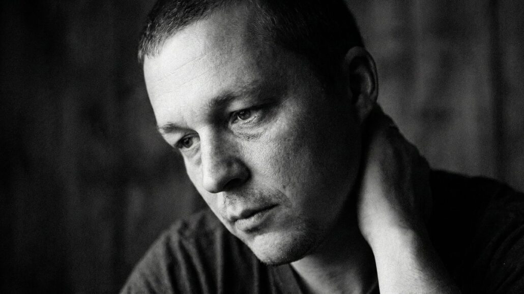 Black and white portrait of Tony Simons looking weary and reflective, illustrating a post about digital burnout and online toxicity in 2025.